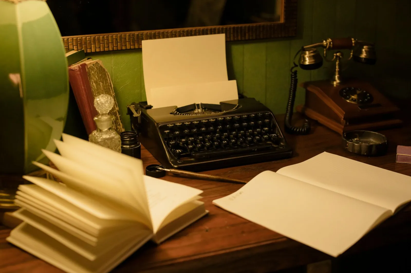 A cozy vintage desk setup featuring a classic typewriter, books, and a retro lamp for an authentic nostalgic feel.
