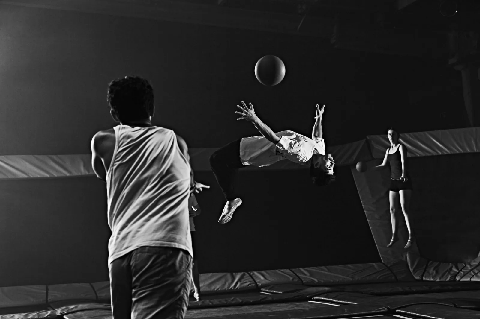 Dynamic dodgeball game with acrobatic moves on indoor trampolines.