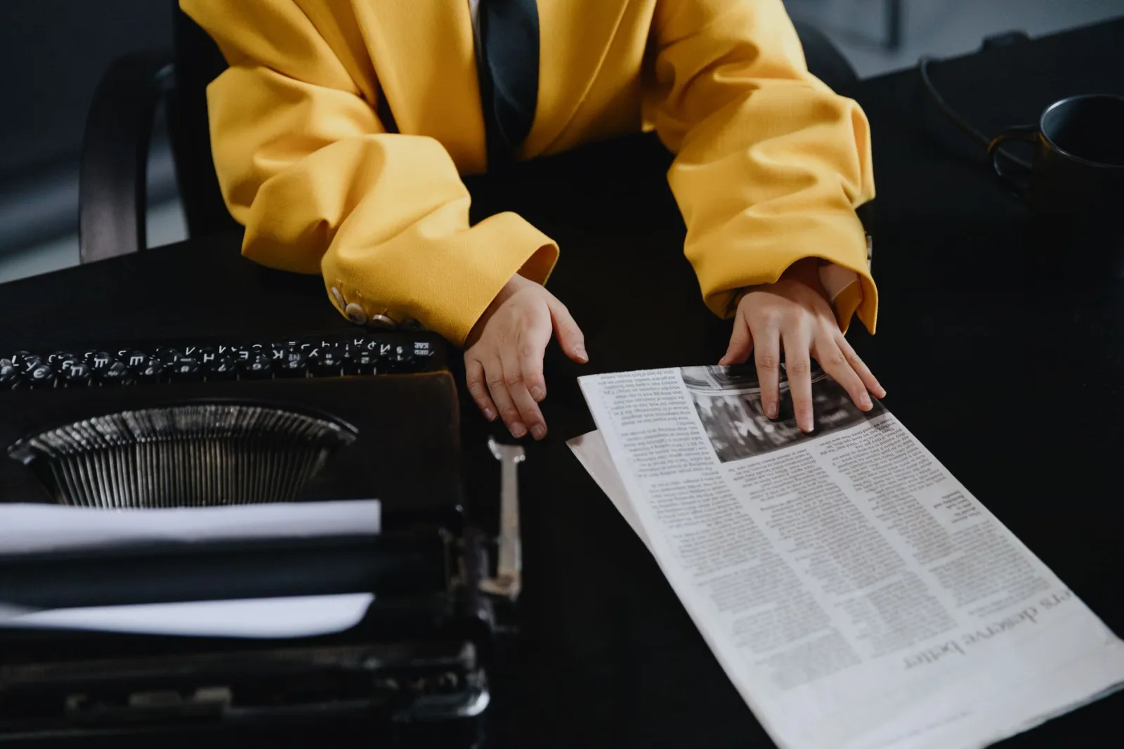 Stara maszyna do pisania i złożone gazety na biurku